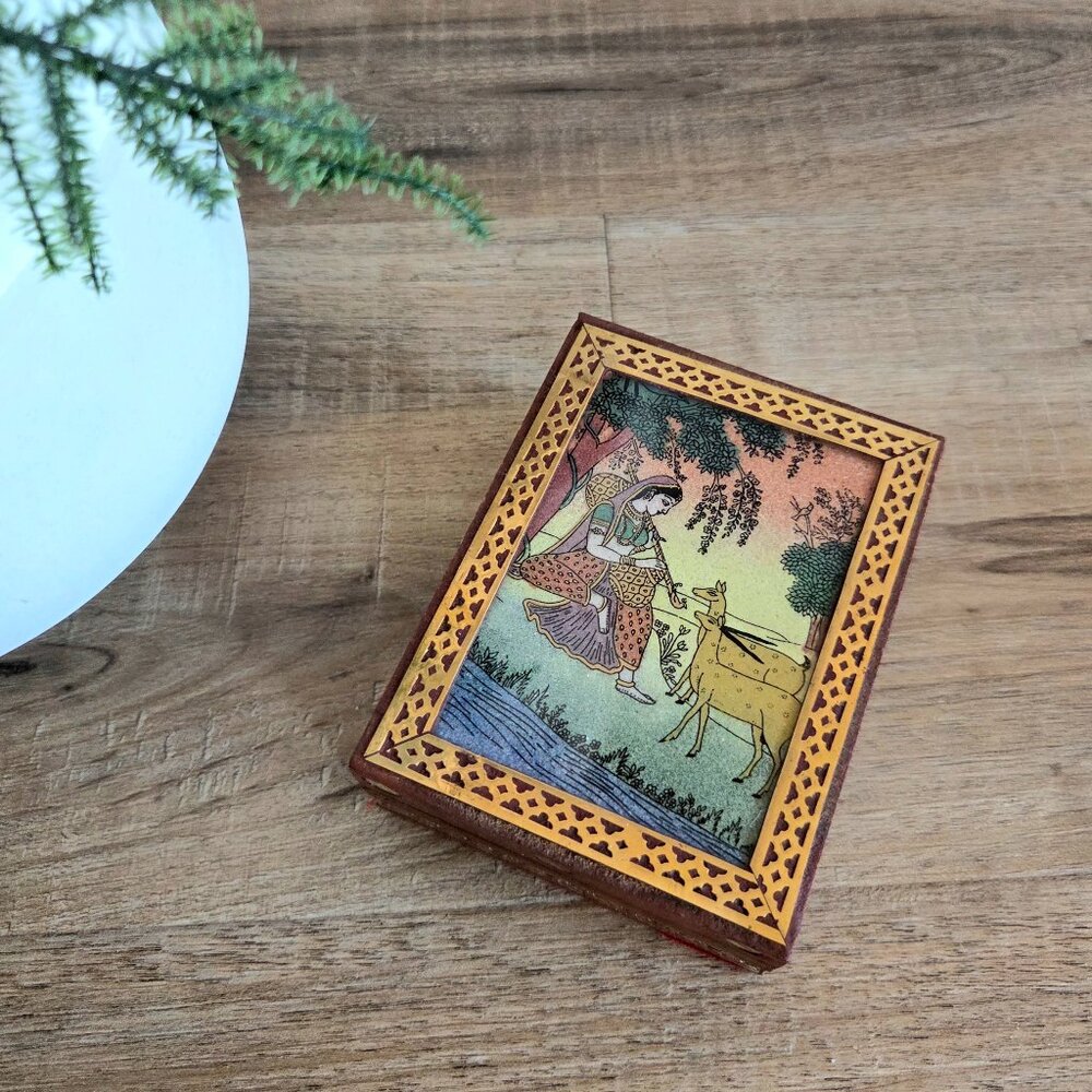 Vintage wooden jewelry/trinket box with inlayed brass details and painting.